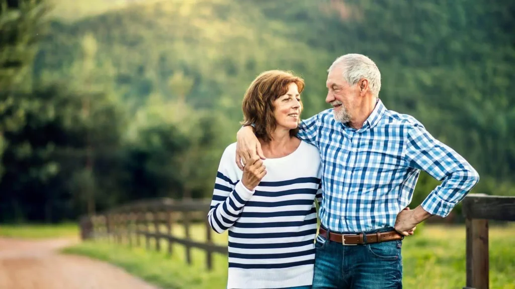 Photo of a couple walking in nature in an article about what happens in your marriage when you go too long without sex.